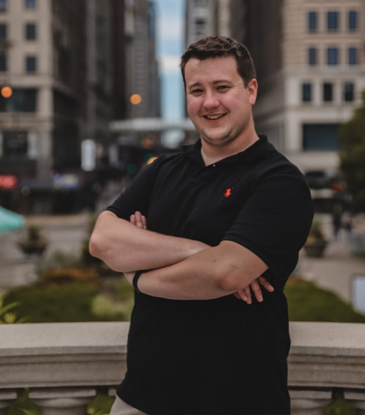 Man standing in downtown Chicago with arms folded